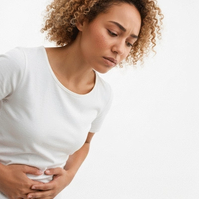 Woman holding her lower abdomen in discomfort, representing ovarian health issues